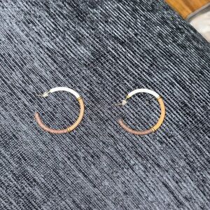 open hoop earrings featuring a colorful, wrapped thread or bead design.